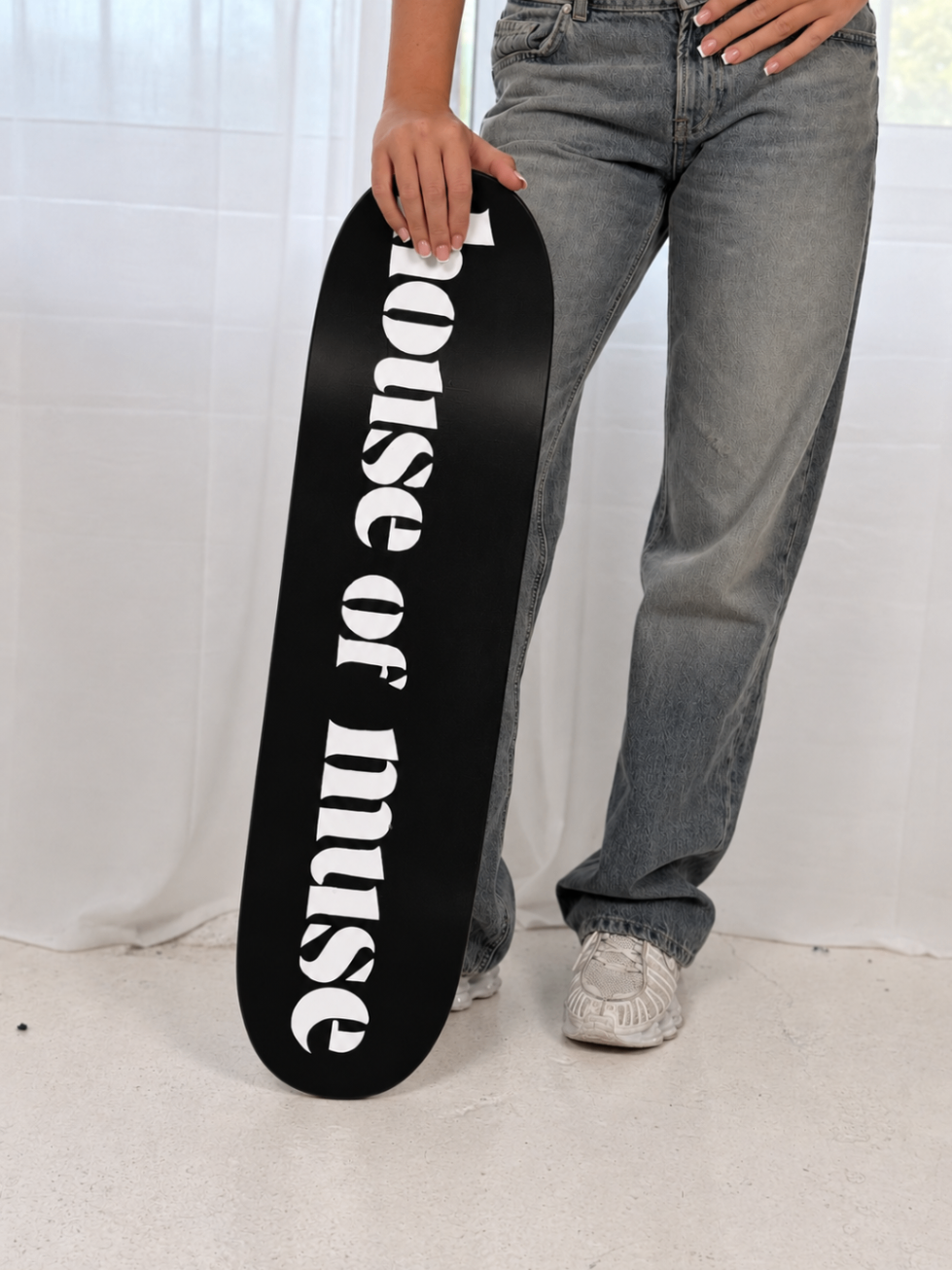 House of Muse skateboard deck styled with grey denim
