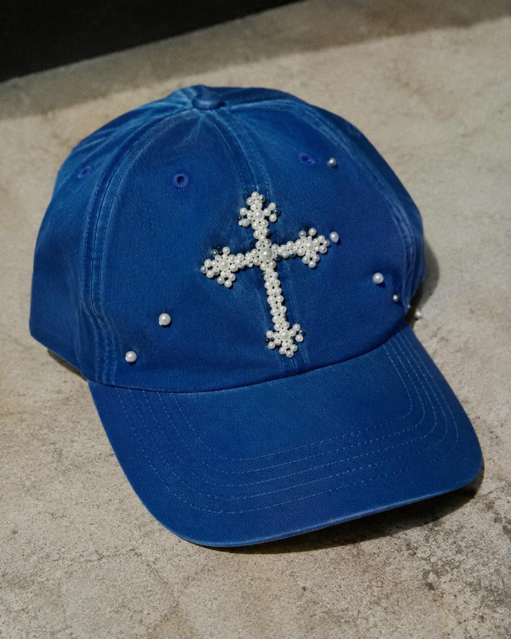 Blue cap hand-finished with a pearl cross